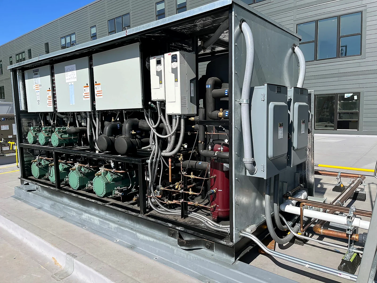 Commercial CO2 compressor rack installation with controls and pipework